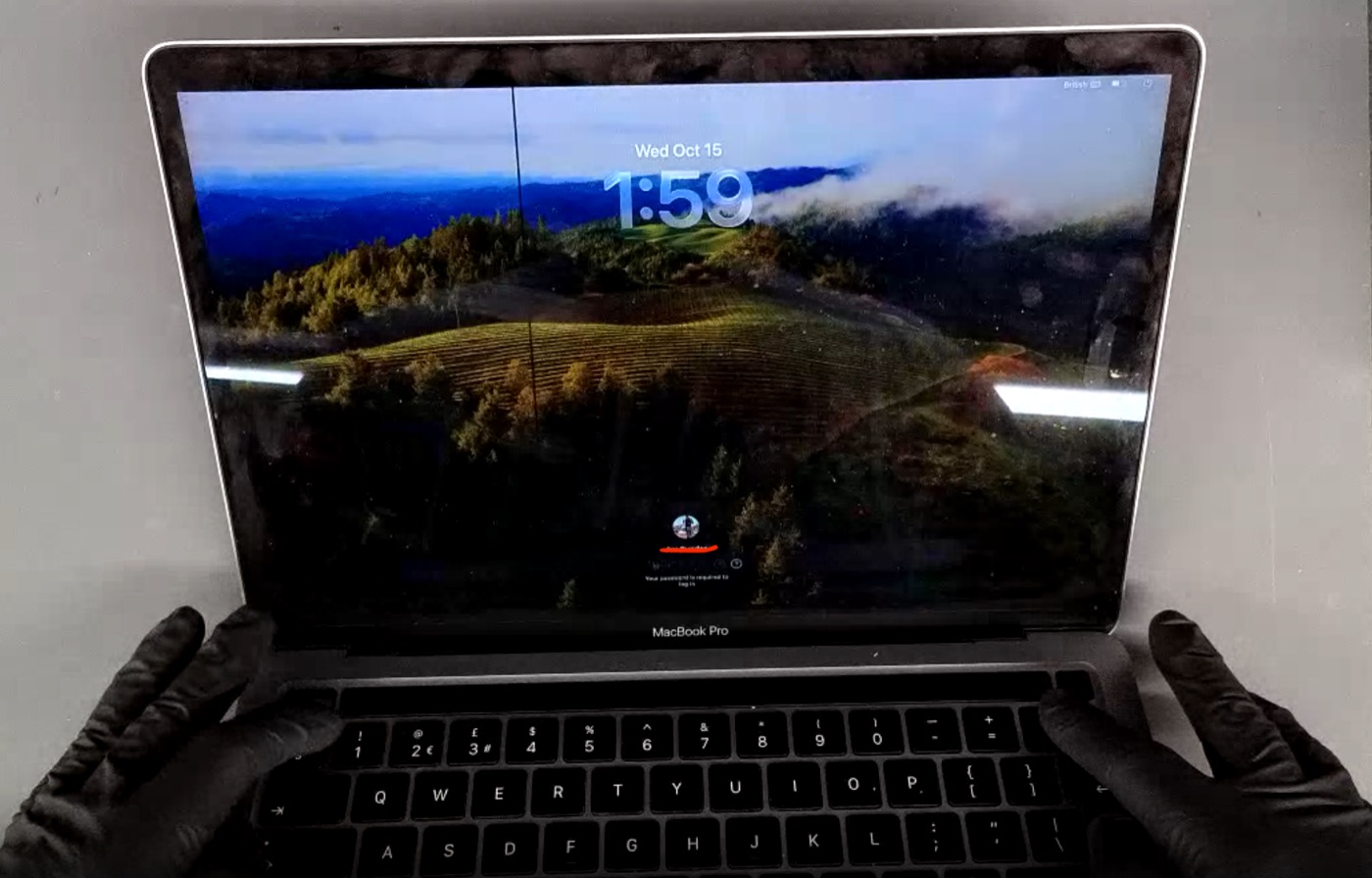 MacBook screen physical damage example — Faint vertical line, display still working