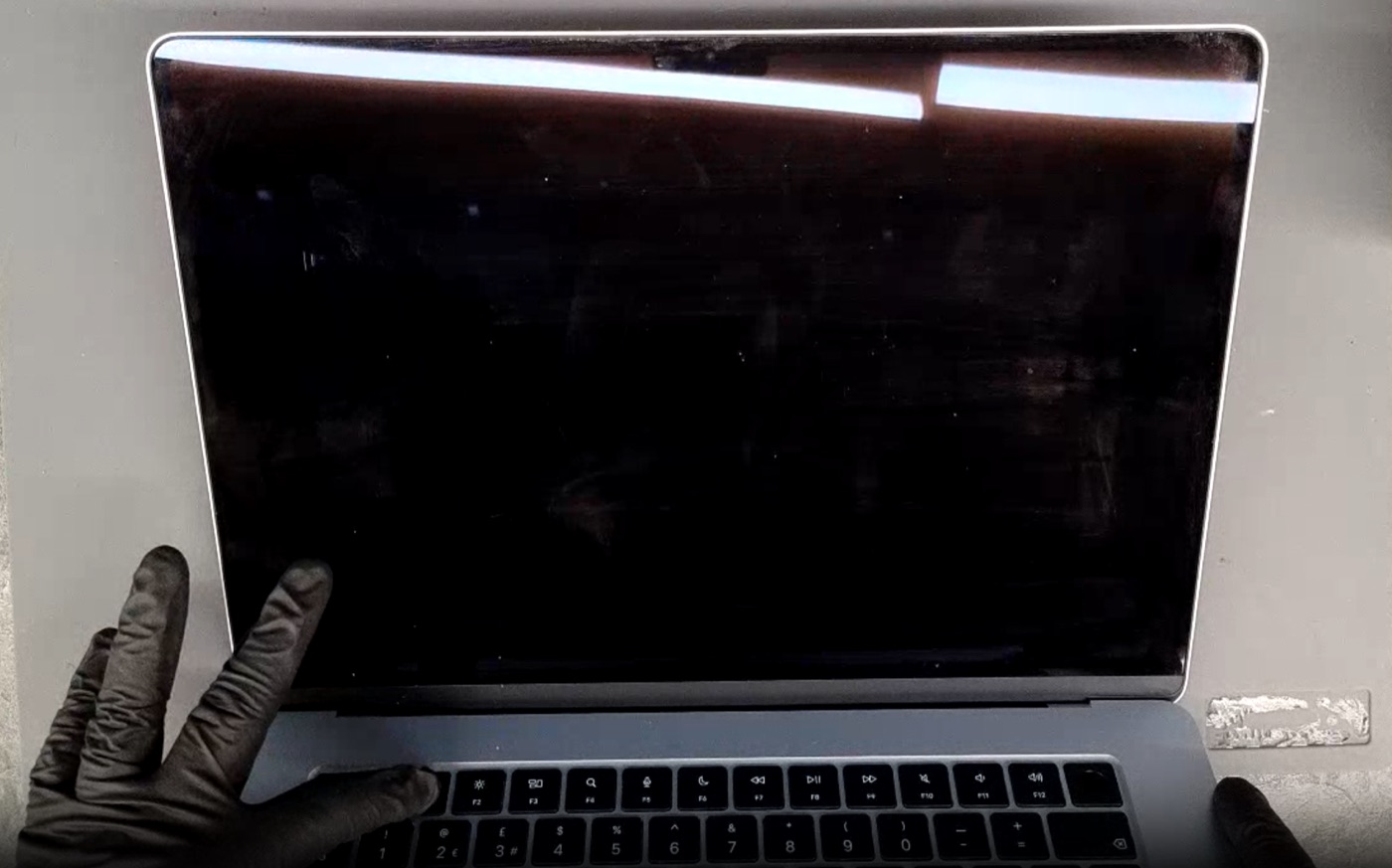 MacBook screen physical damage example — Completely black display — no image at all