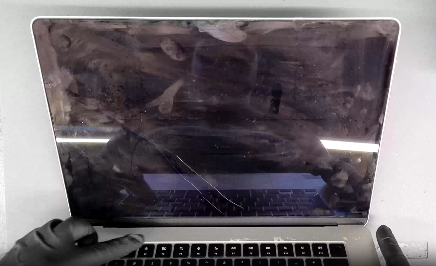 MacBook screen physical damage example — Dark, unresponsive panel from internal damage